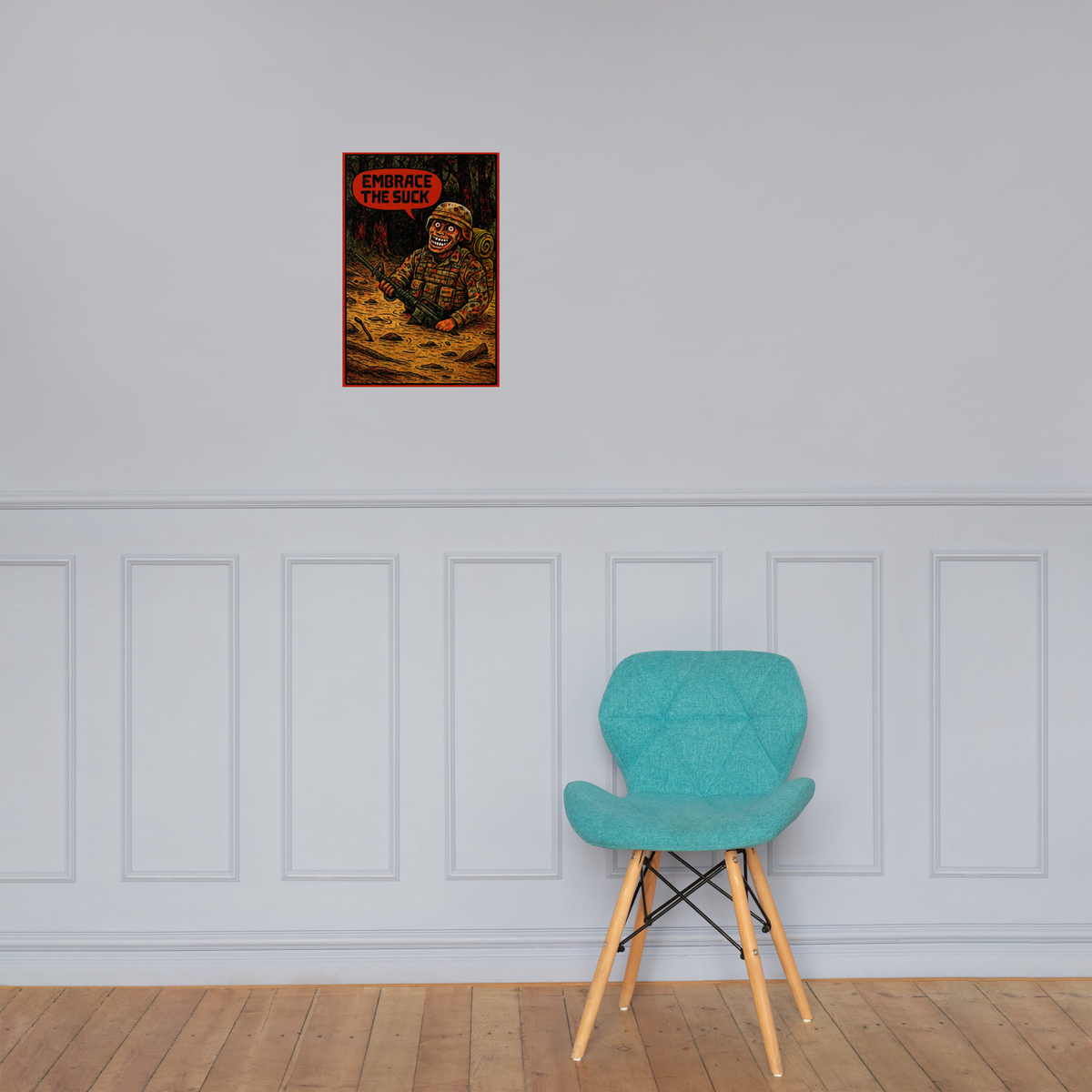 Embrace the Suck: 12 in by 18 in glossy poster on a paneled wall above a turquoise chair; Printful room mockup.