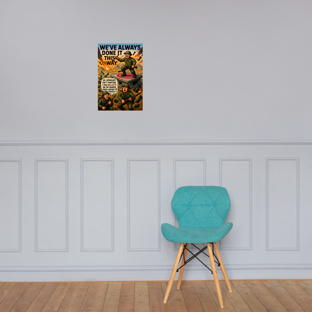 We've Always Done It This Way: 12 in by 18 in glossy poster on a paneled wall above a turquoise chair; Printful room mockup.